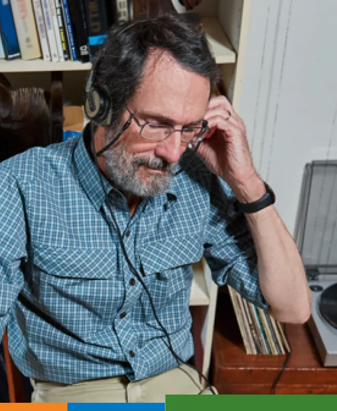 Man listening to music on a record player